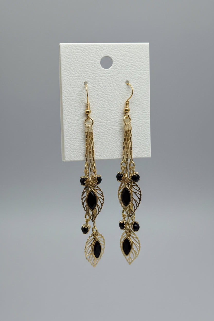 Aretes Largos Dorados con Hojas y Piedras Negras – Oro Laminado